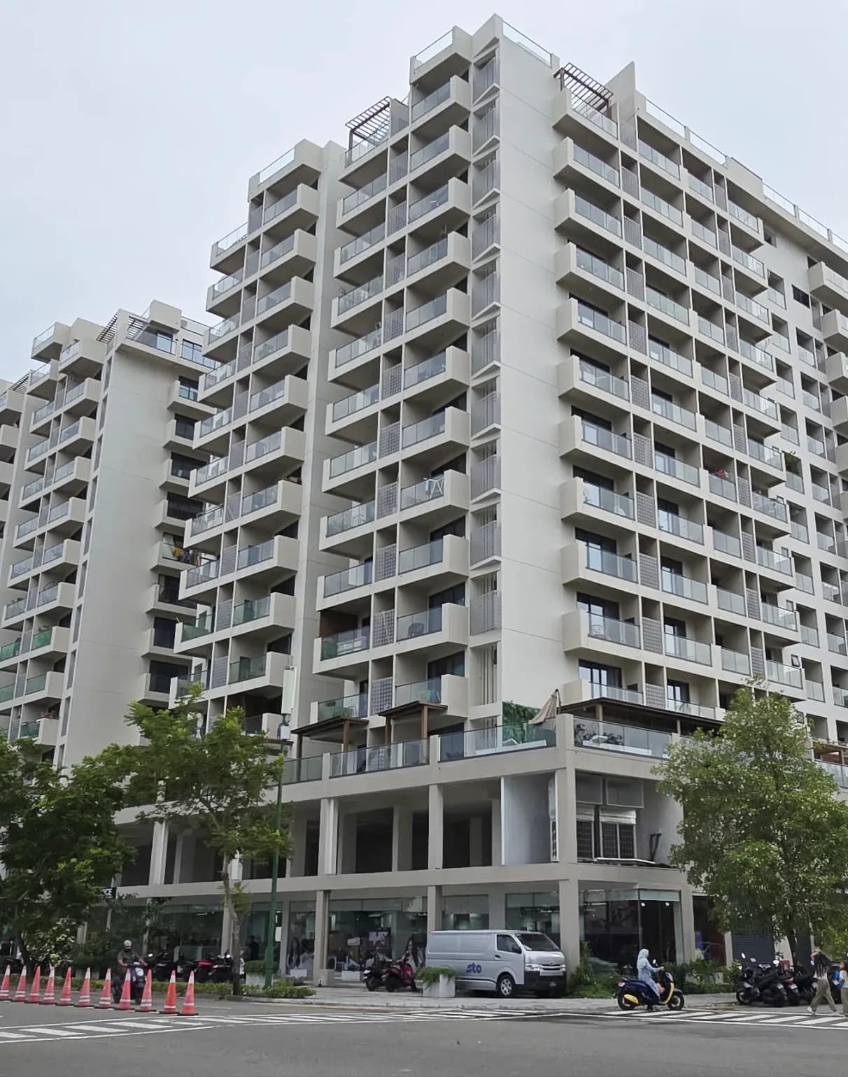 Street-level photograph of RainCoral Residence, a 14-storey twin-tower condominium in Hulhumalé.