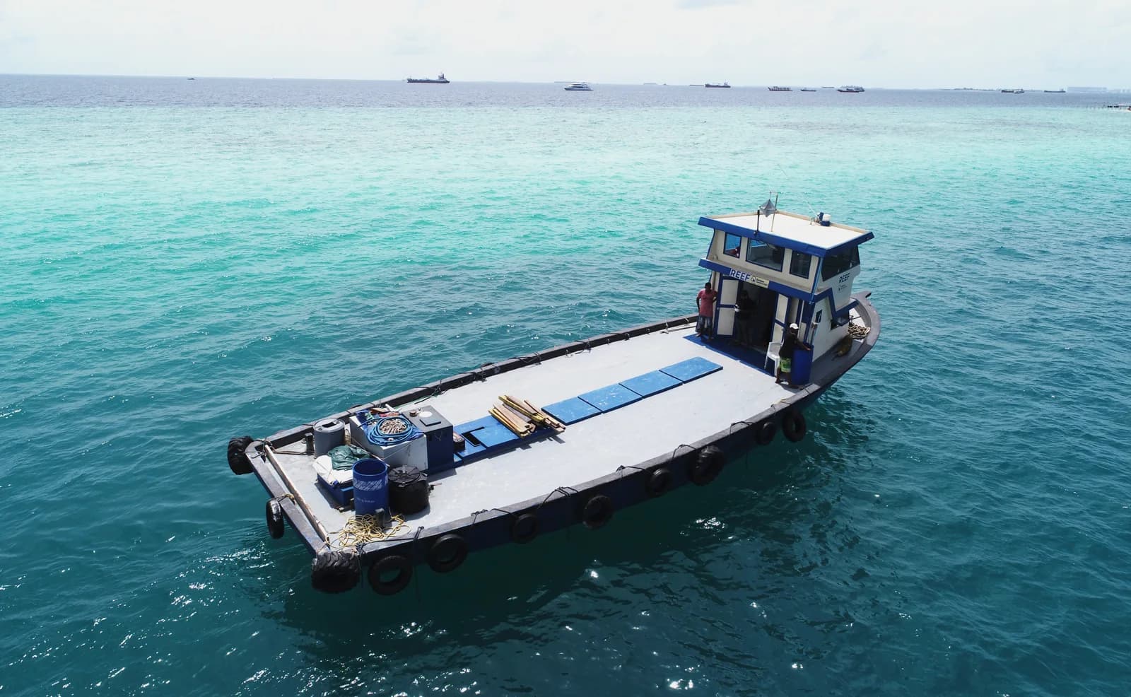 Reef Dhoni 60 MT cargo vessel over turquoise water.