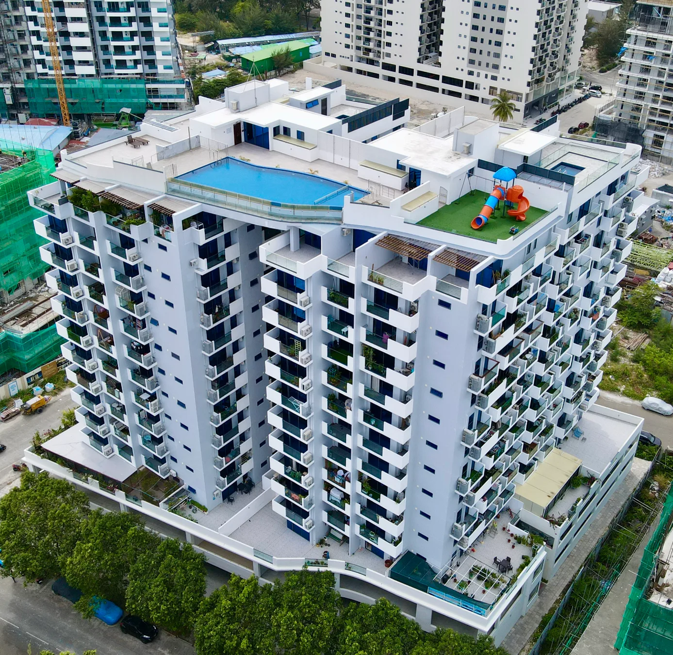 Aerial photograph of RainCrest Residence in Hulhumalé, a twin-tower condominium with a rooftop pool.