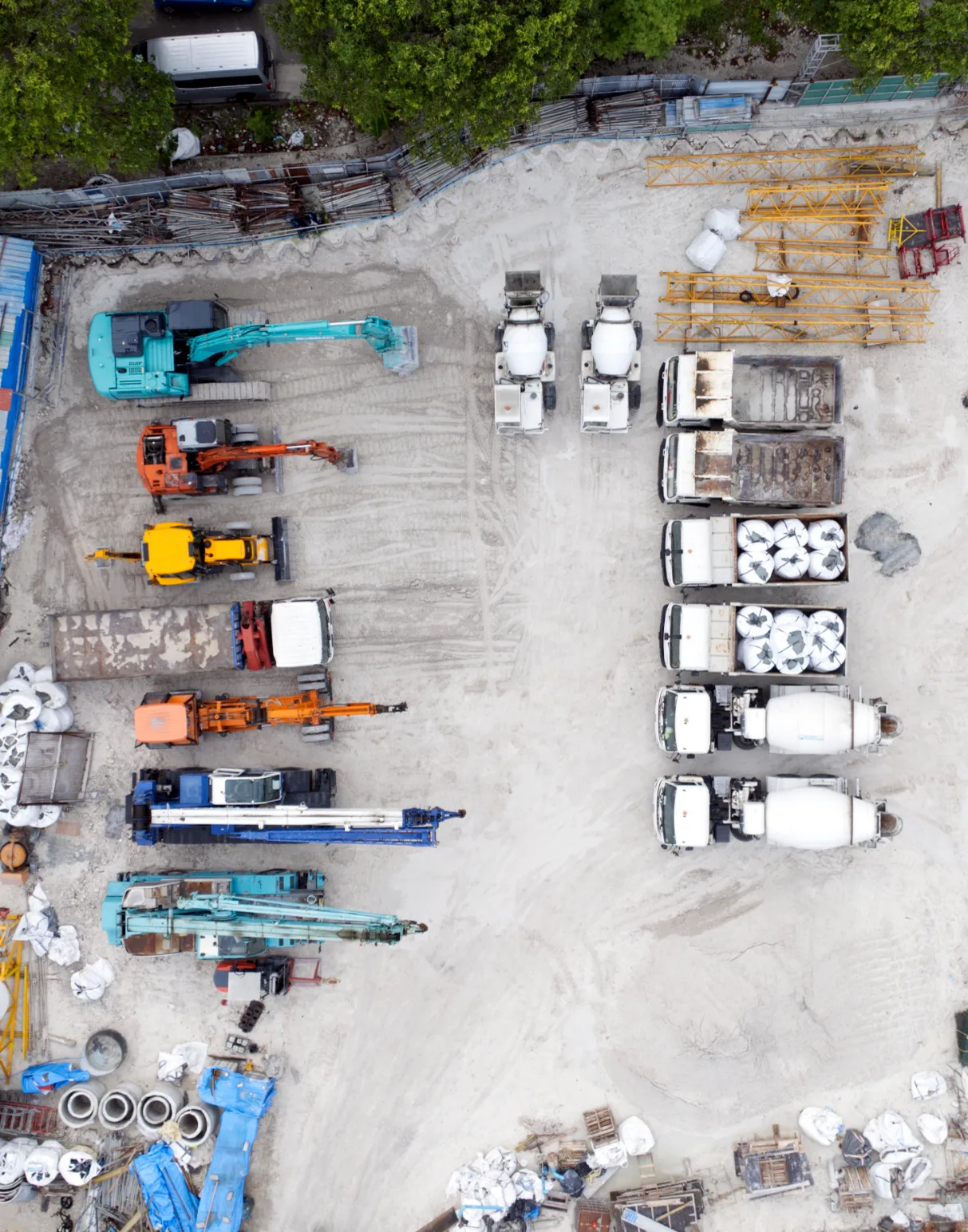 Aerial photograph of Rainbow Construction's yard: cranes, excavators, mixers and materials.